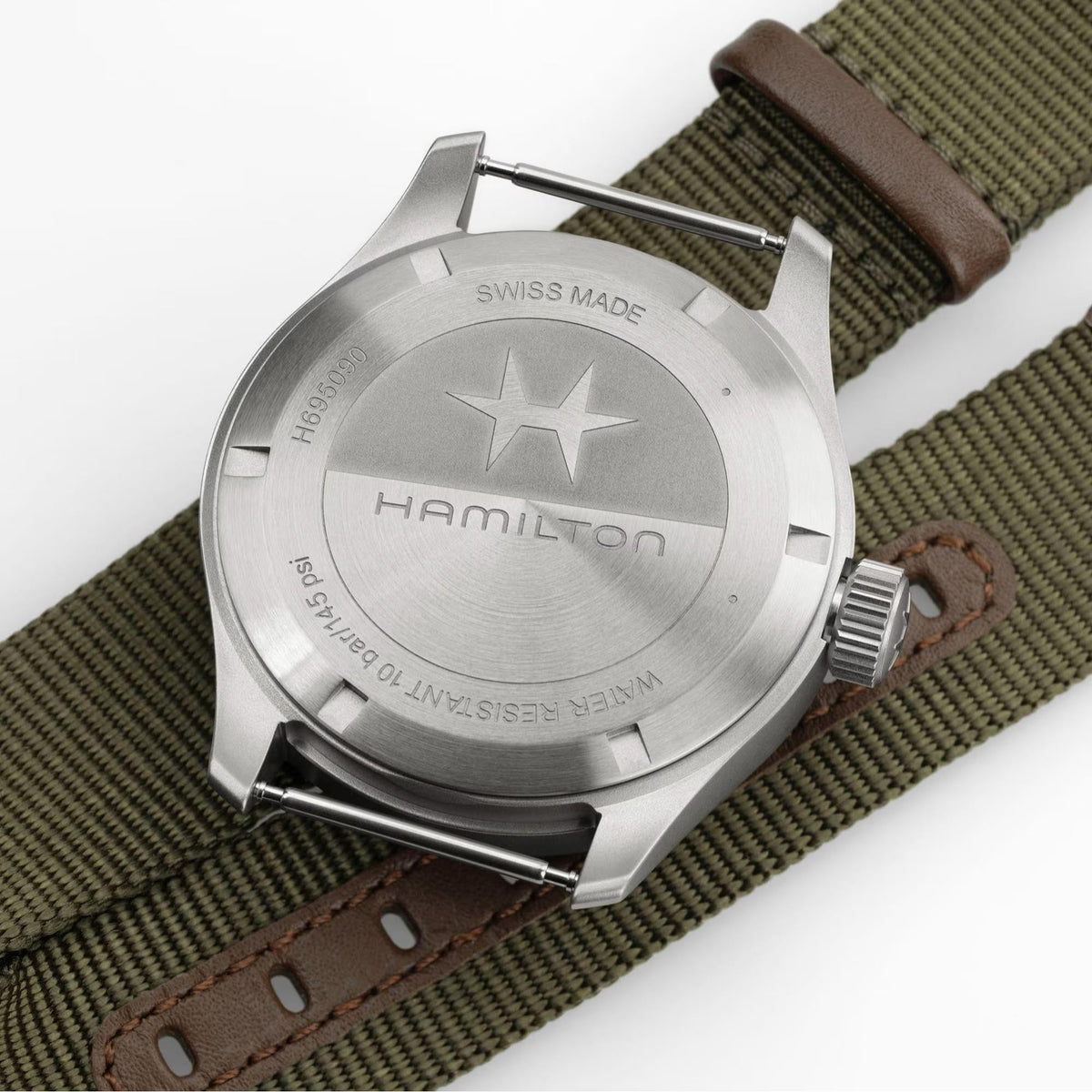 Hamilton Khaki Field H69509930 watch reverse perspective showing engraved stainless steel case back and olive green NATO strap with leather loops