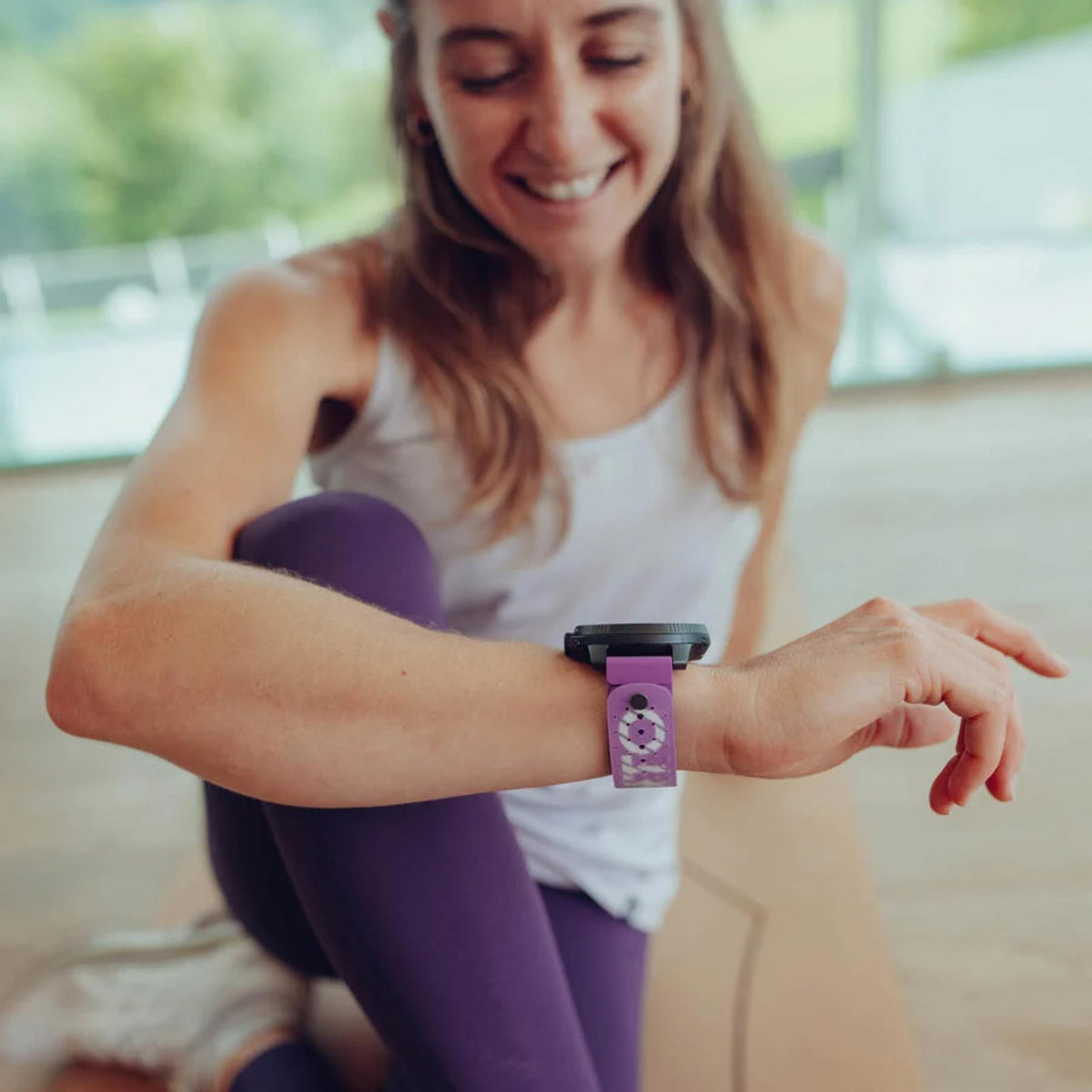 Orchid purple silicone watch strap on wrist with smartwatch face, adjustable band