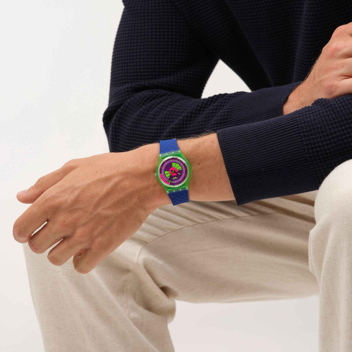 Quartz watch on arm with purple dial and blue textured silicone strap