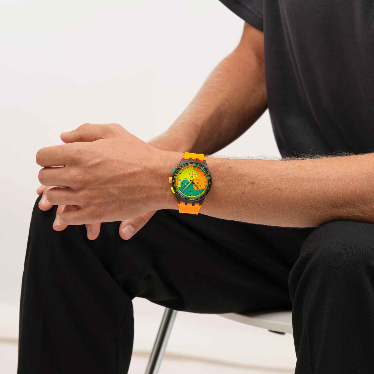 Orange silicone strap chronograph quartz watch with green/orange multicolor dial on wrist