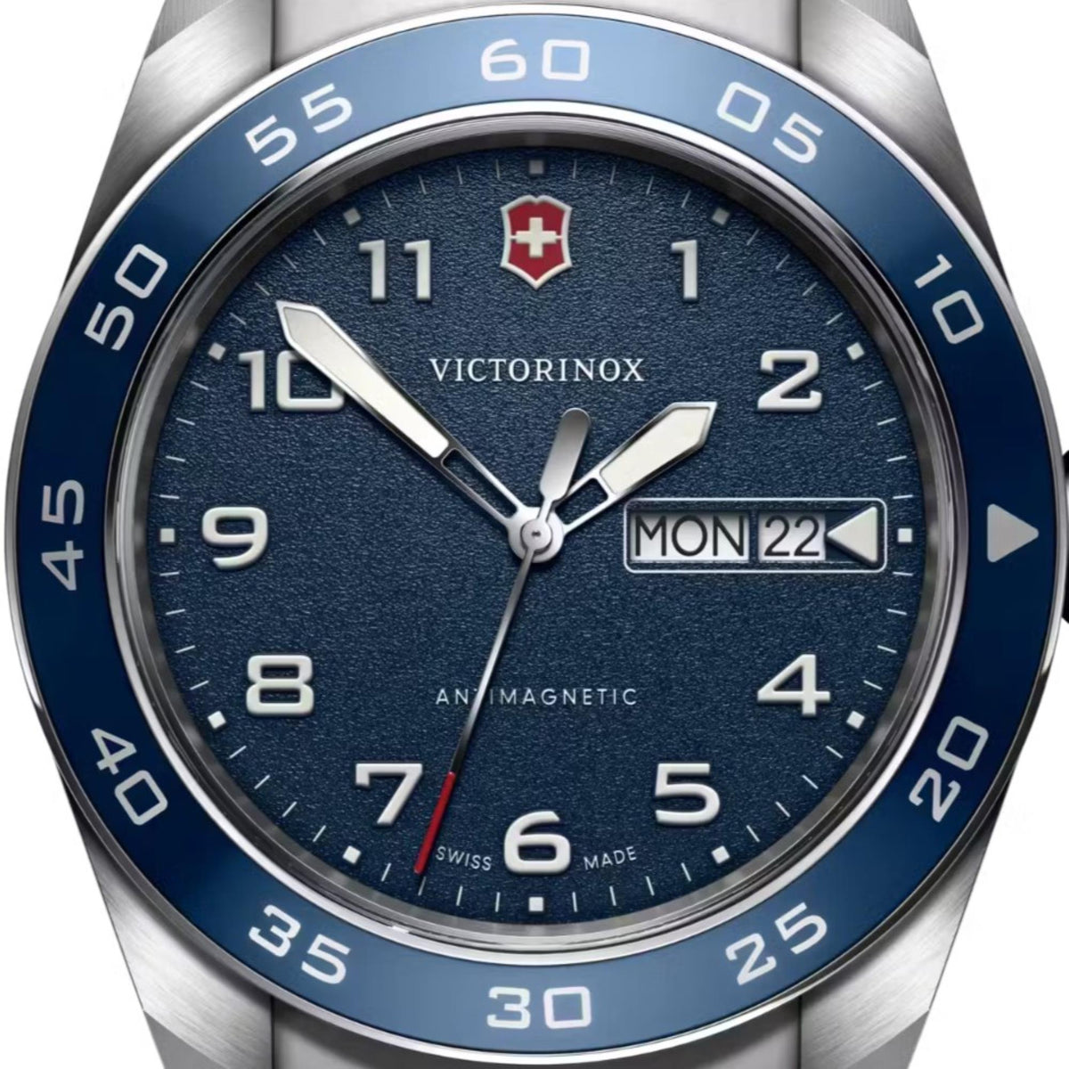 Blue dial men's quartz watch with silver hands, date window, and Victorinox crest