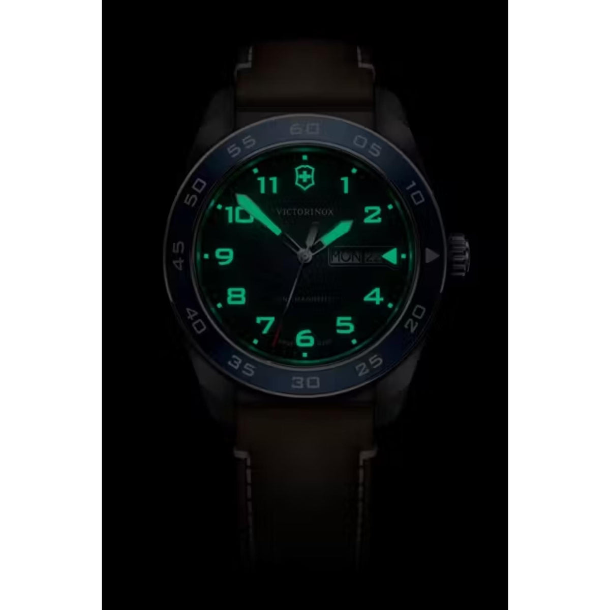Blue dial quartz watch with glowing green hands and hour markers, date display