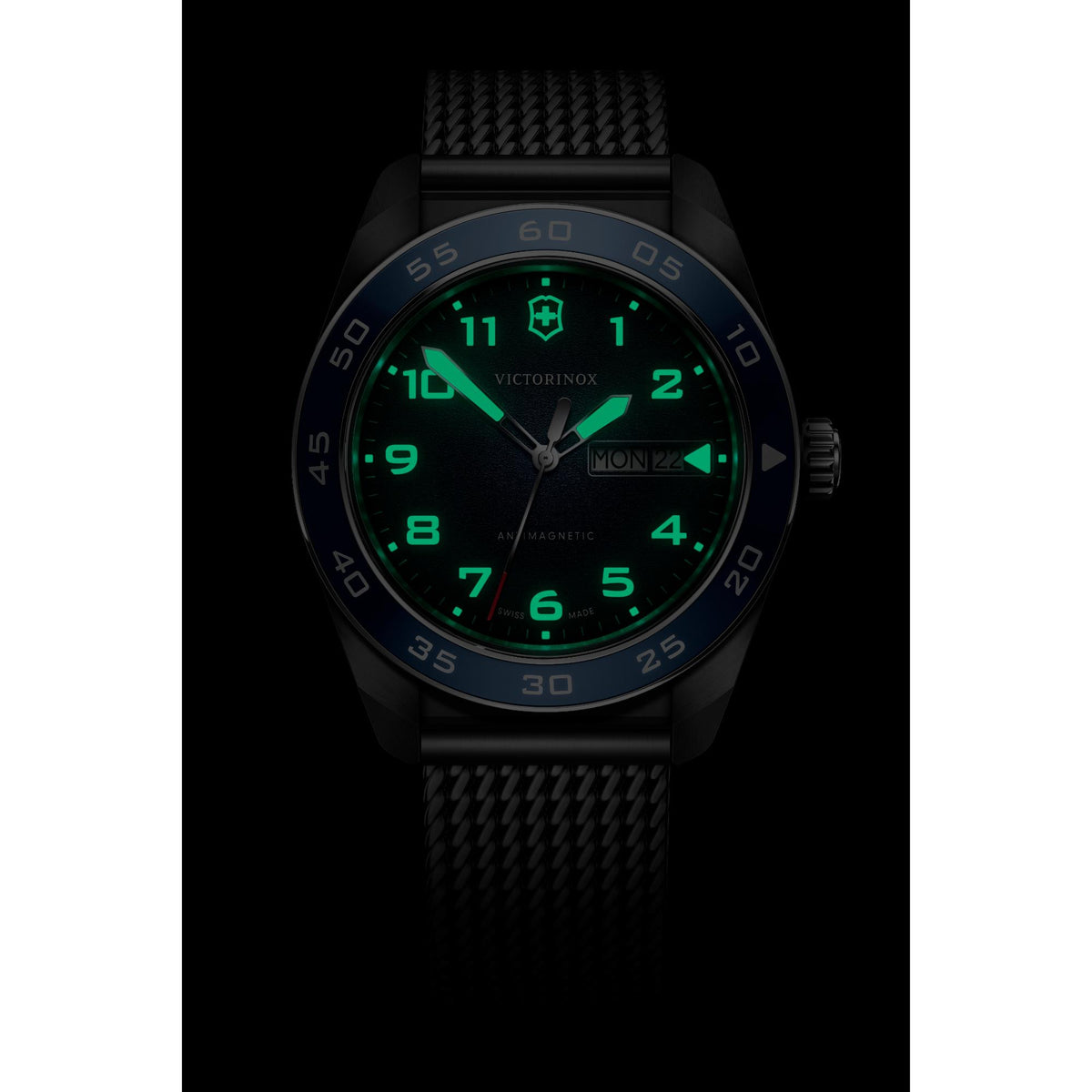 Victorinox Swiss Army watch in low light with green lumed blue bezel and date window