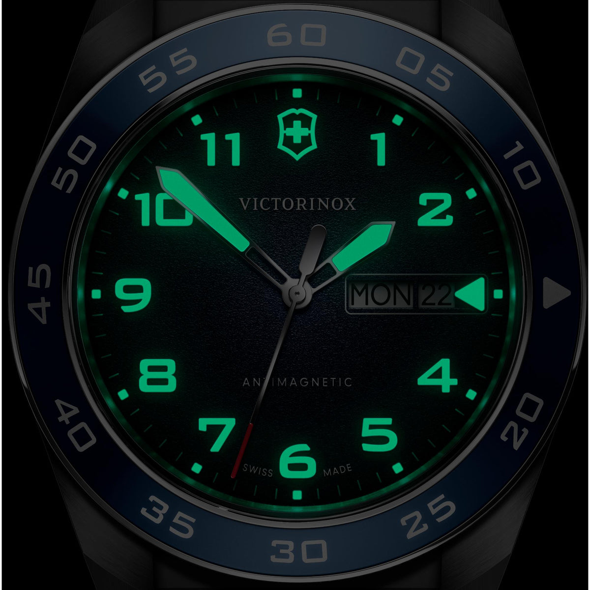 Victorinox Swiss Army watch close-up blue dial with green lumed markers and MON 22 date