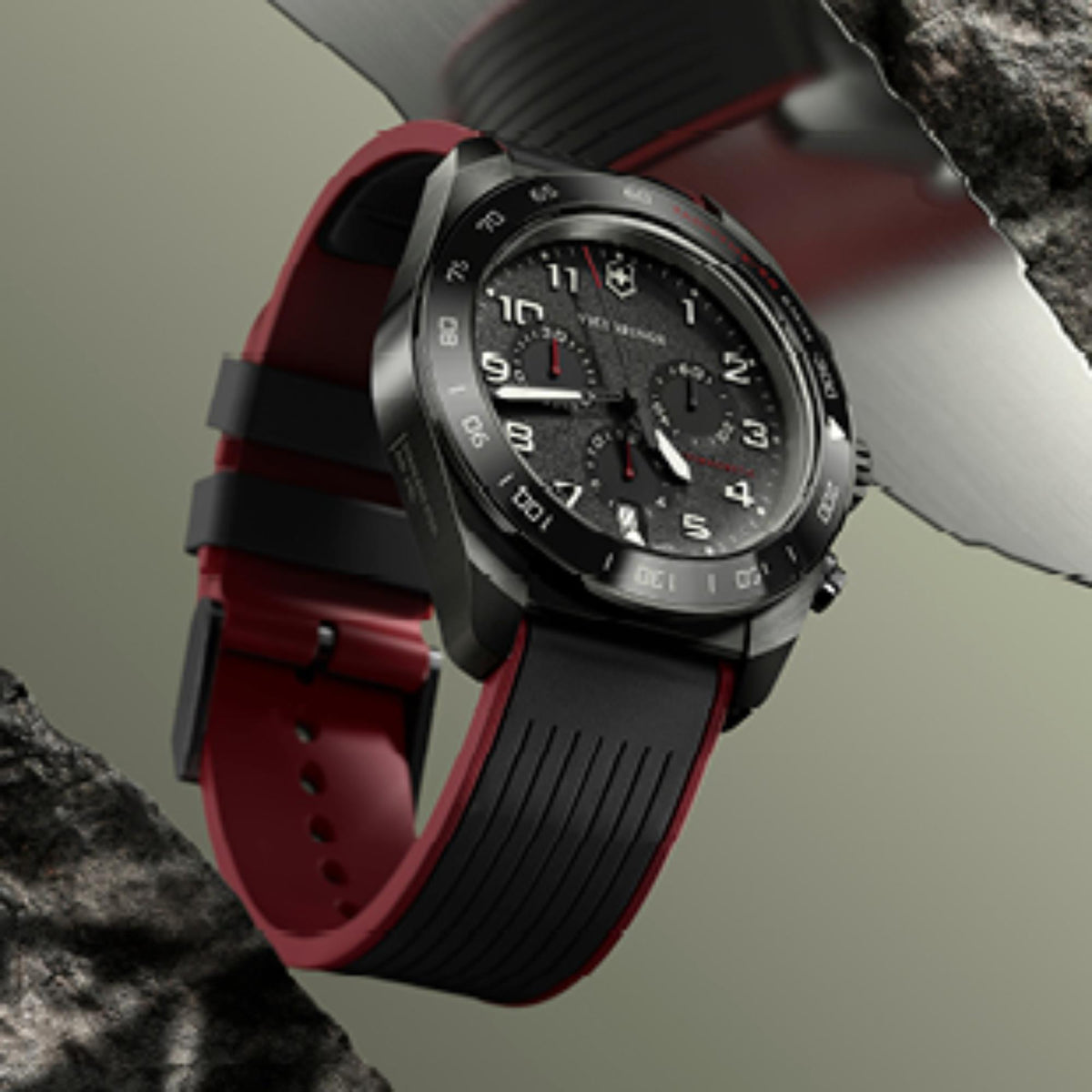 Chronograph watch with black dial and red rubber strap, silver crown and pushers