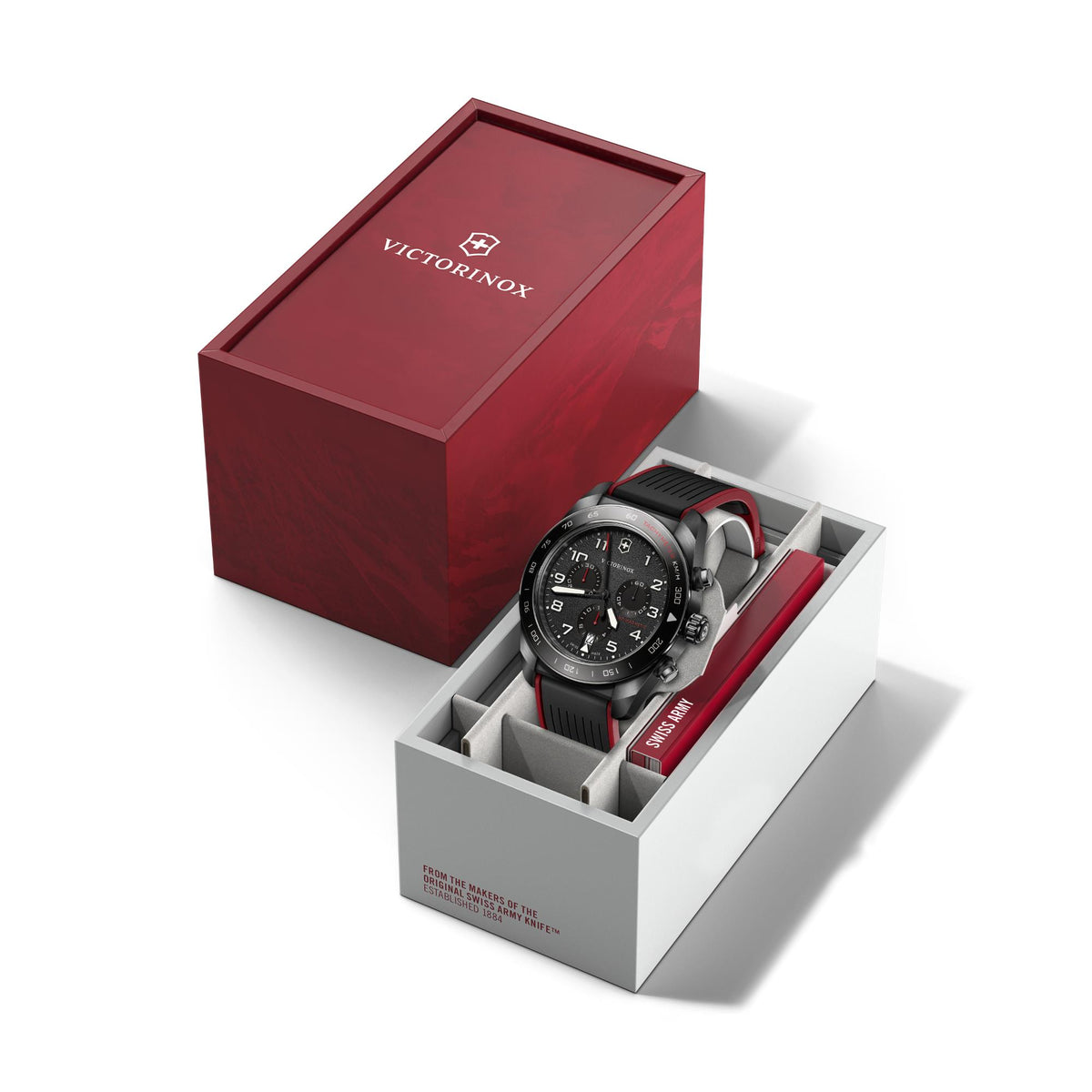 Men's chronograph watch in Victorinox box, black dial and red rubber strap visible