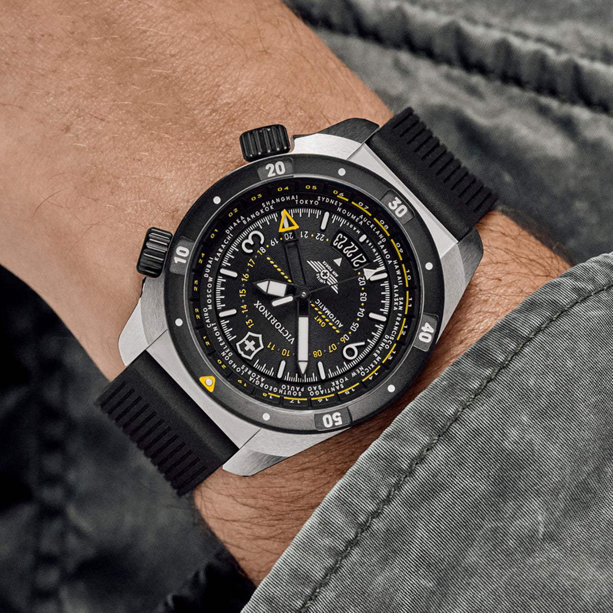 Men’s automatic GMT watch with black dial and black rubber strap on wrist