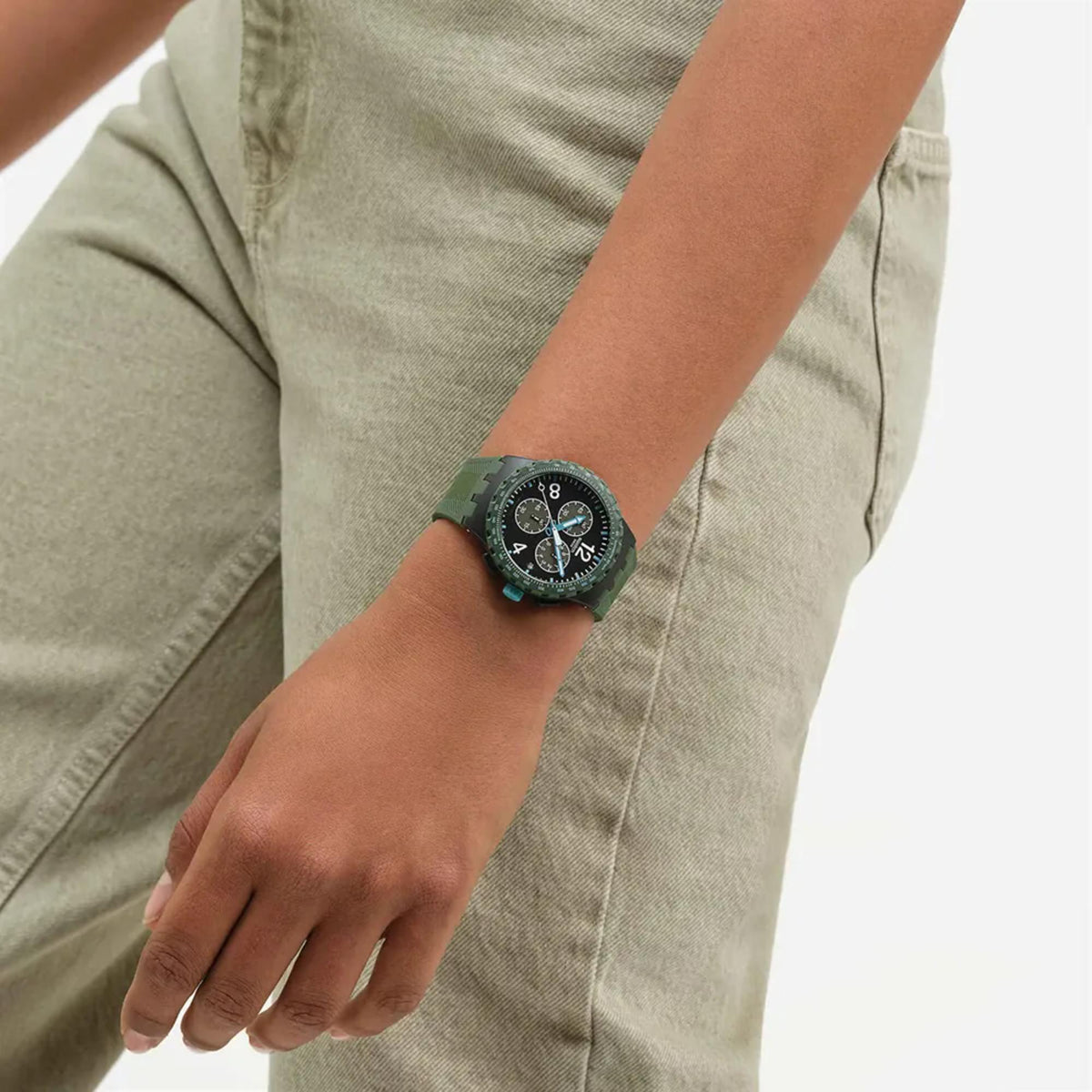 Chronograph watch with green silicone strap and dark black dial on wrist