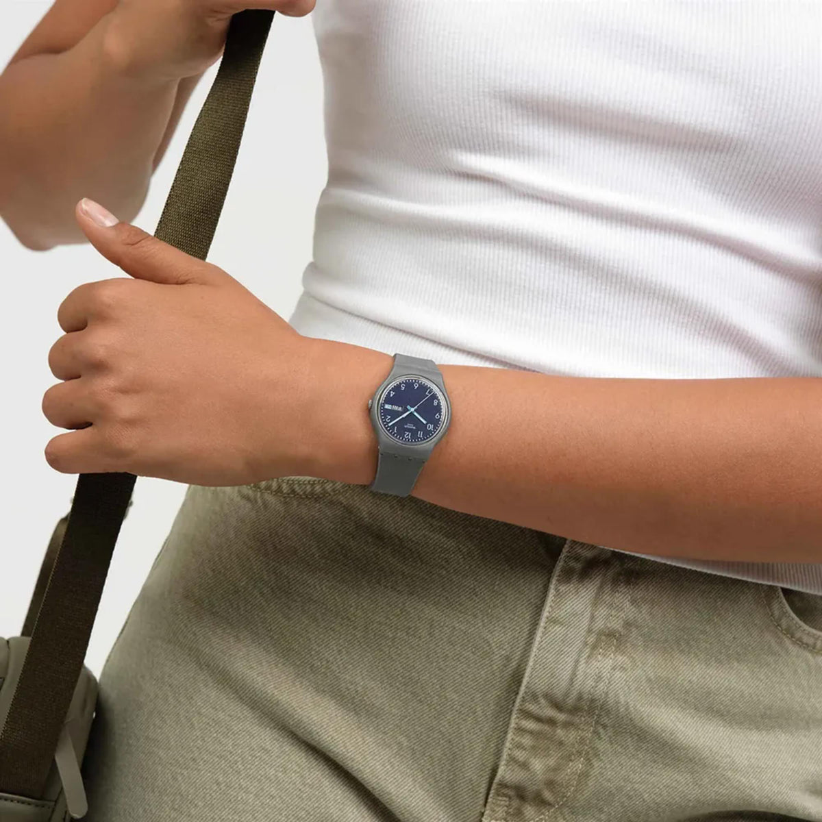Blue dial quartz watch with gray silicone strap, analog time display, day/date window