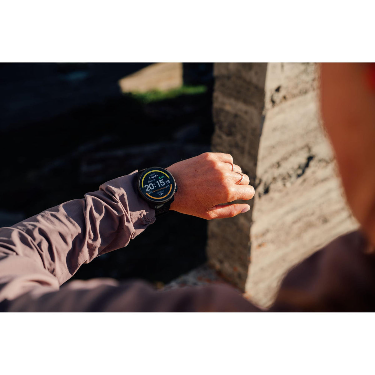 Suunto Vertical 2 All Black SS051204000 smartwatch worn on the wrist outdoors, showing the active AMOLED dial