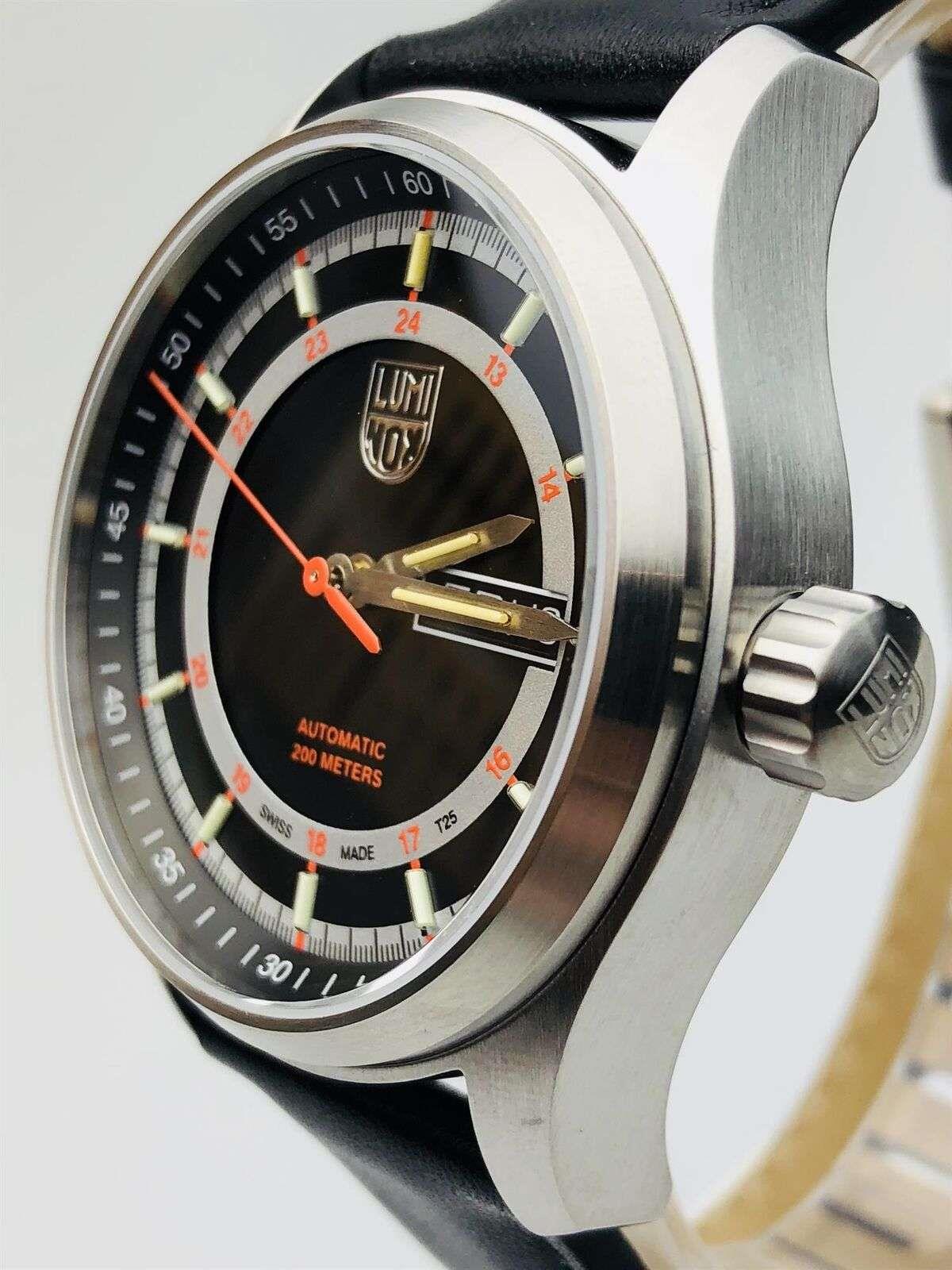 Men's automatic watch angled close-up, black dial, gold-tone hands, stainless side crown