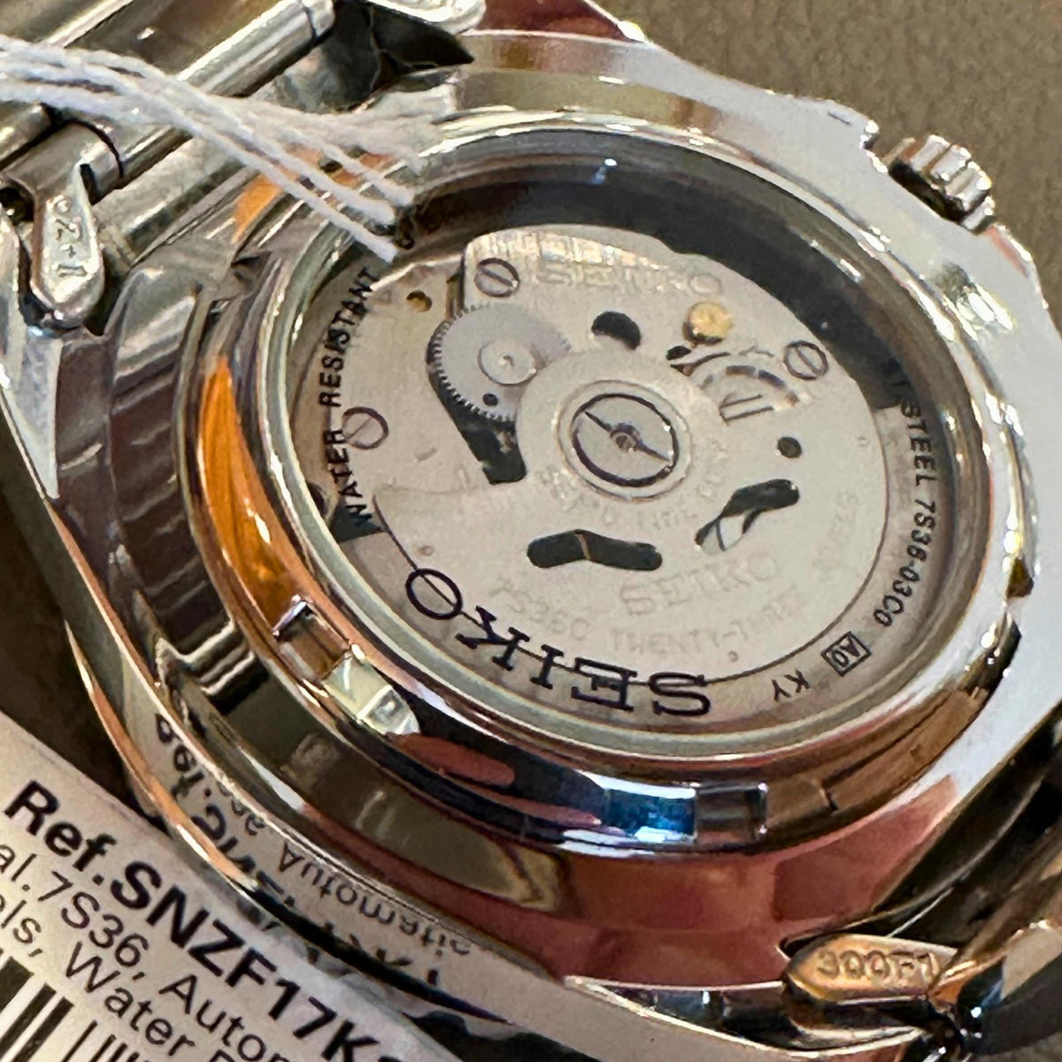 Stainless steel Seiko automatic caseback with exposed movement and crown-side details