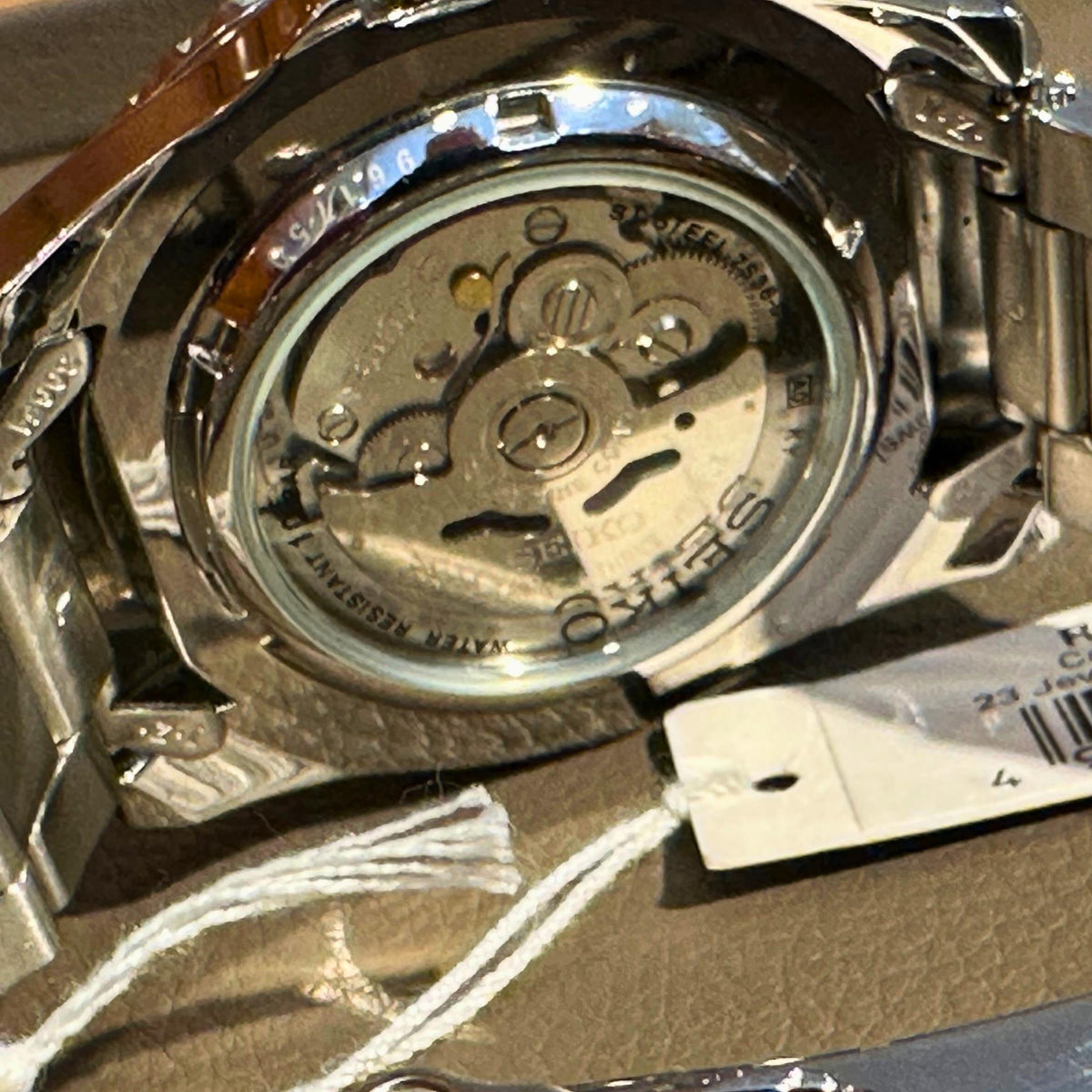 Seiko Sports stainless steel caseback showing automatic movement gears and markings