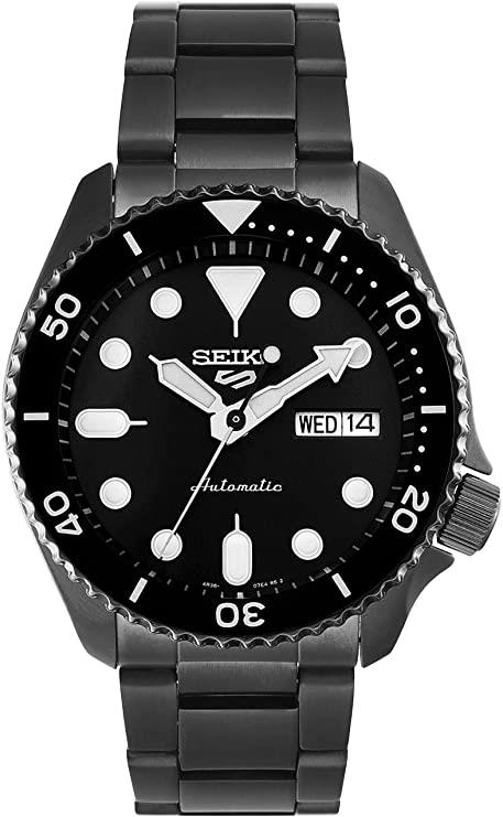 Men's automatic diver watch with black dial and bezel; date window shows WED 14