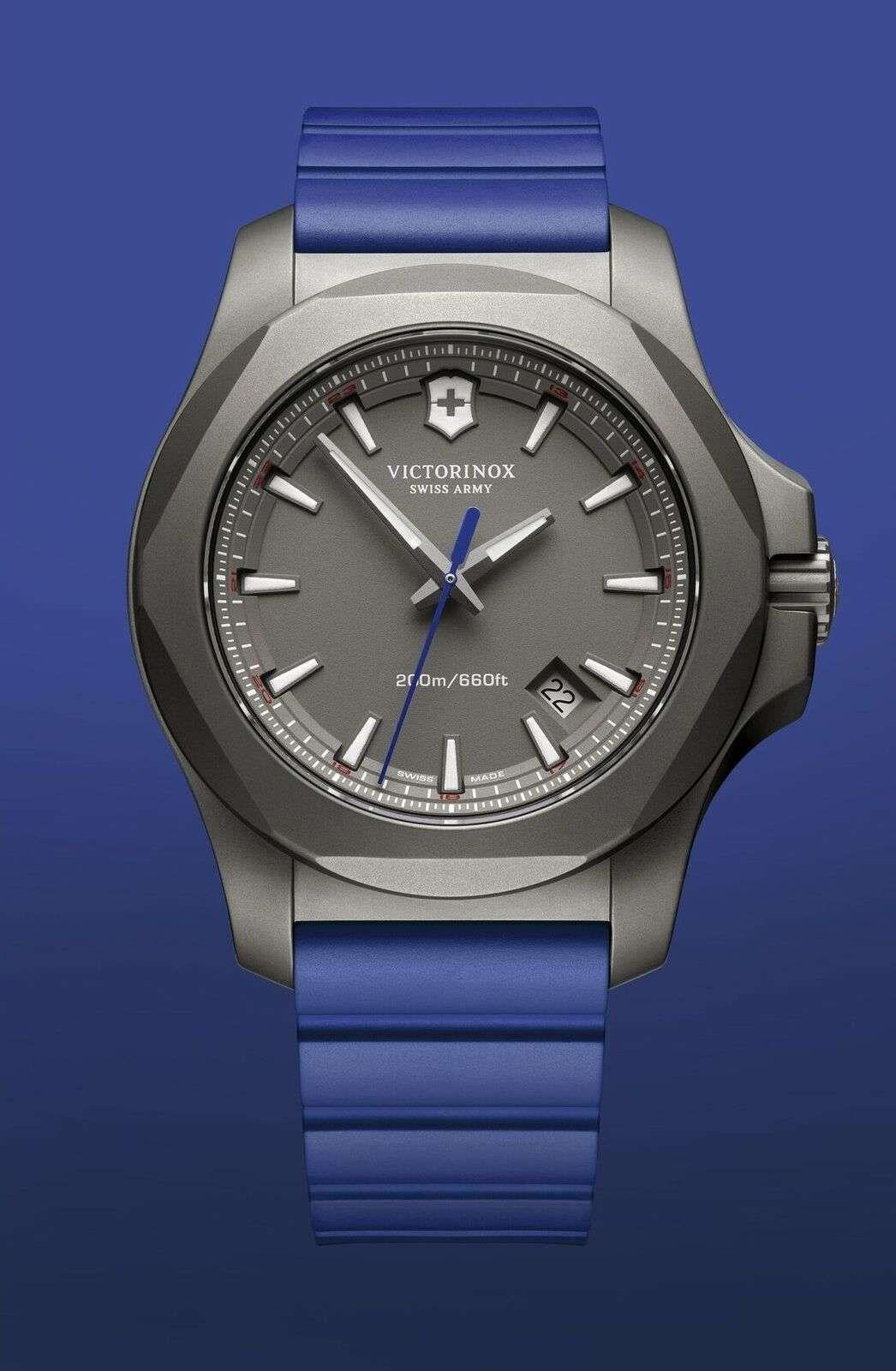 Men's Victorinox watch straight-on view with blue rubber strap and gray case.