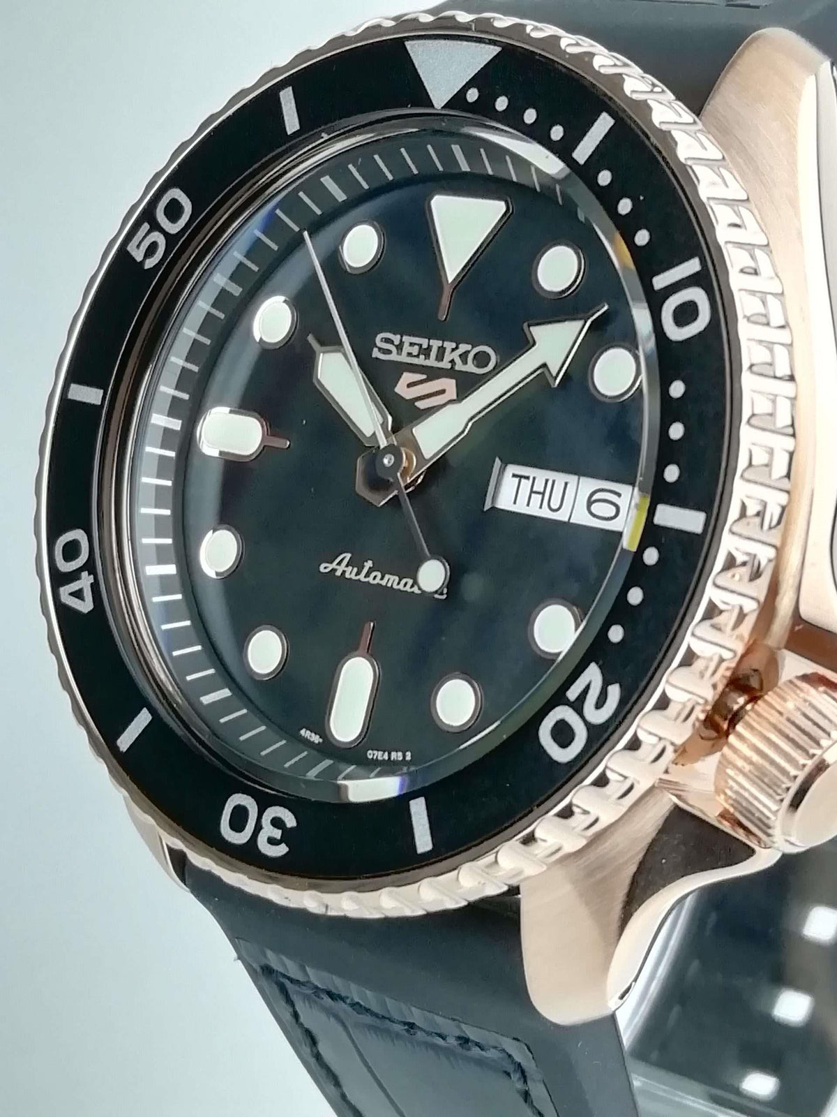 Men's Seiko 5 Sports automatic watch close-up, dark blue-black dial, date window, black strap