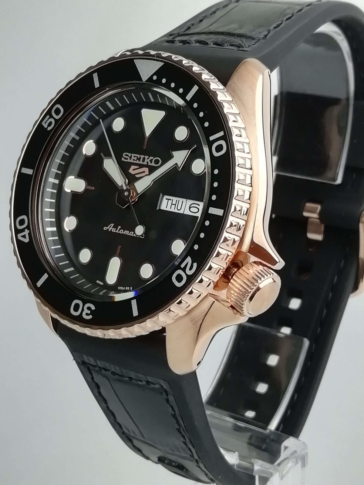 Men's Seiko 5 Sports automatic watch angled view, black dial with THU 6, black strap