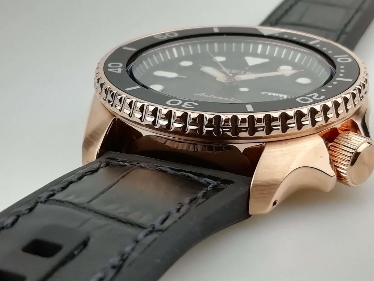 Men's Seiko 5 Sports automatic watch case close-up, black bezel markings and crown, black strap
