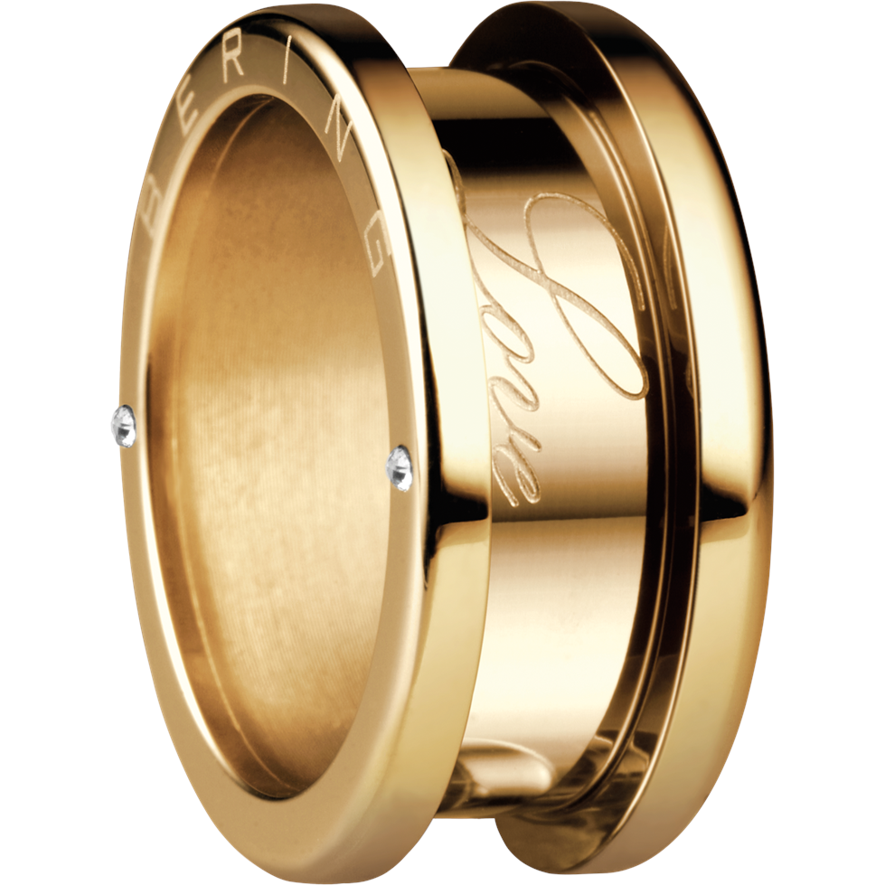 Gold-tone ring with oval face, engraved lines, and two small side stones