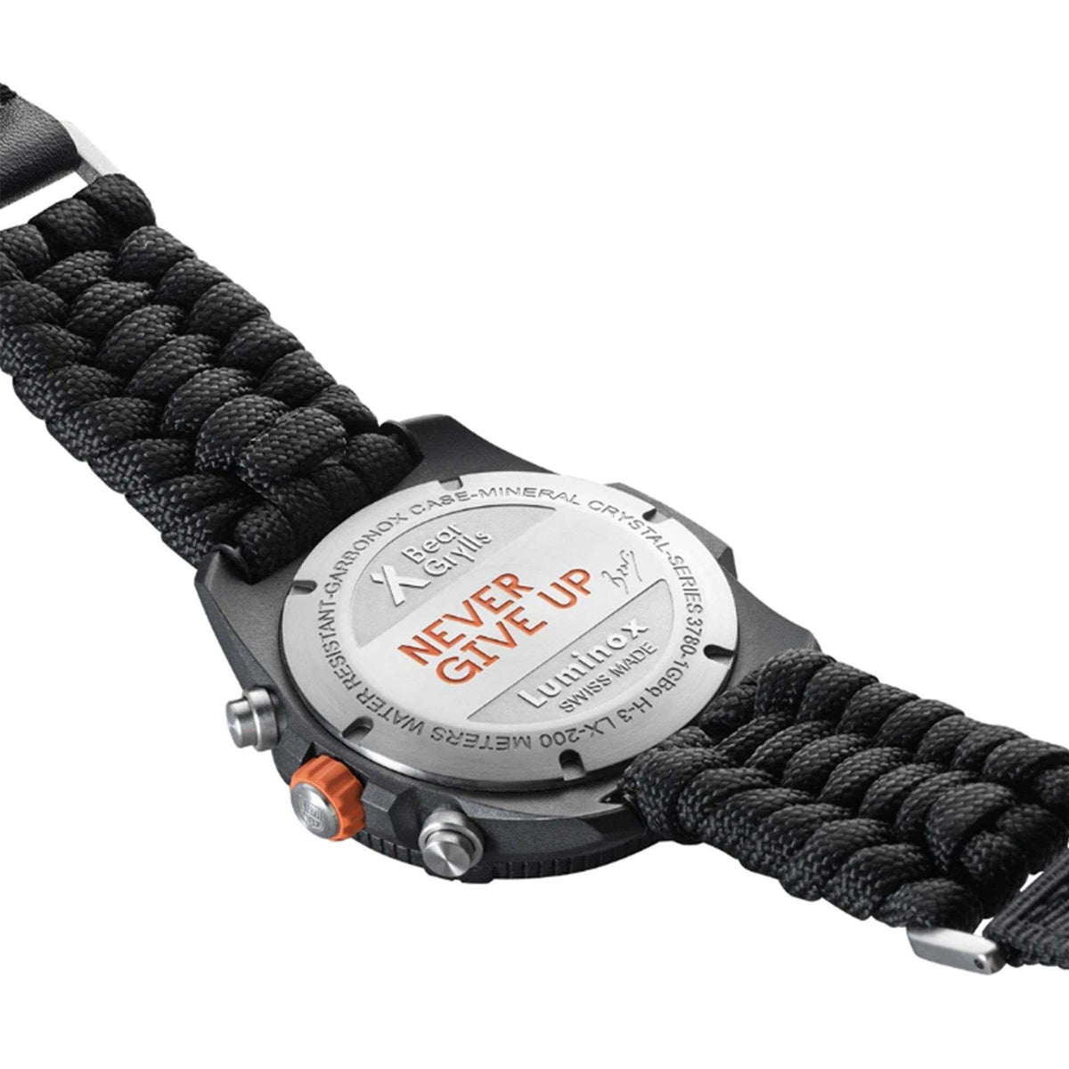 Engraved watch case back on black braided textile strap with orange accent button