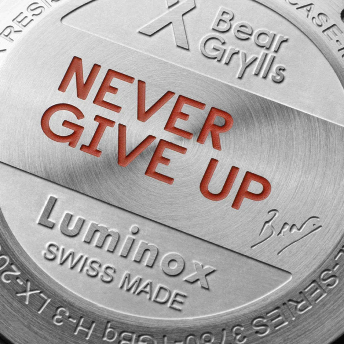 Steel watch case back engraved with 'NEVER GIVE UP' and 'Swiss Made'