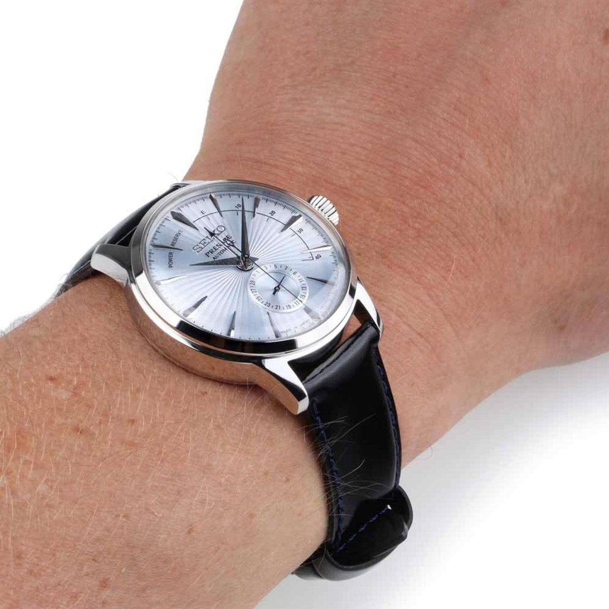 Men’s automatic watch with silver dial and black leather strap, polished steel case