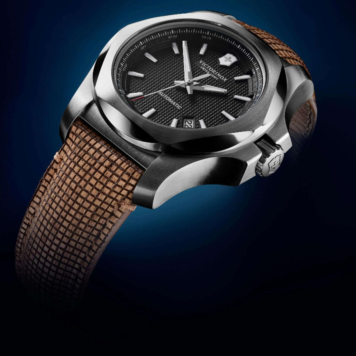 Victorinox I.N.O.X men's mechanical watch angled close-up with black dial and brown woven strap