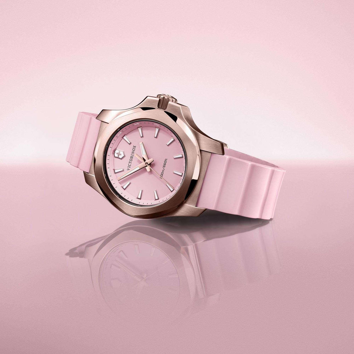 Men's analog wristwatch, rose-gold case with pink dial and pink rubber strap, angled