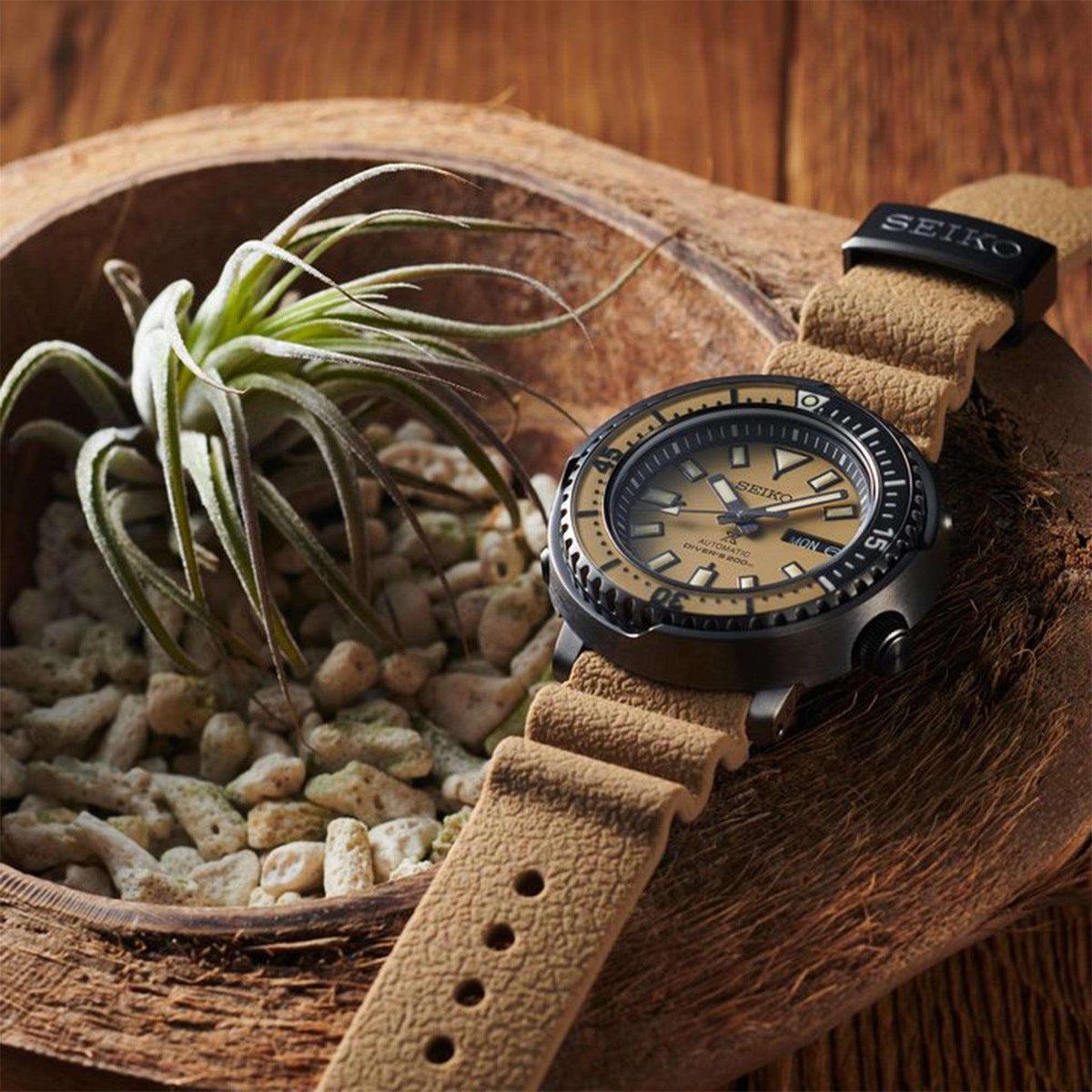 Automatic diver watch side view with beige dial, tan leather strap, black bezel, date window
