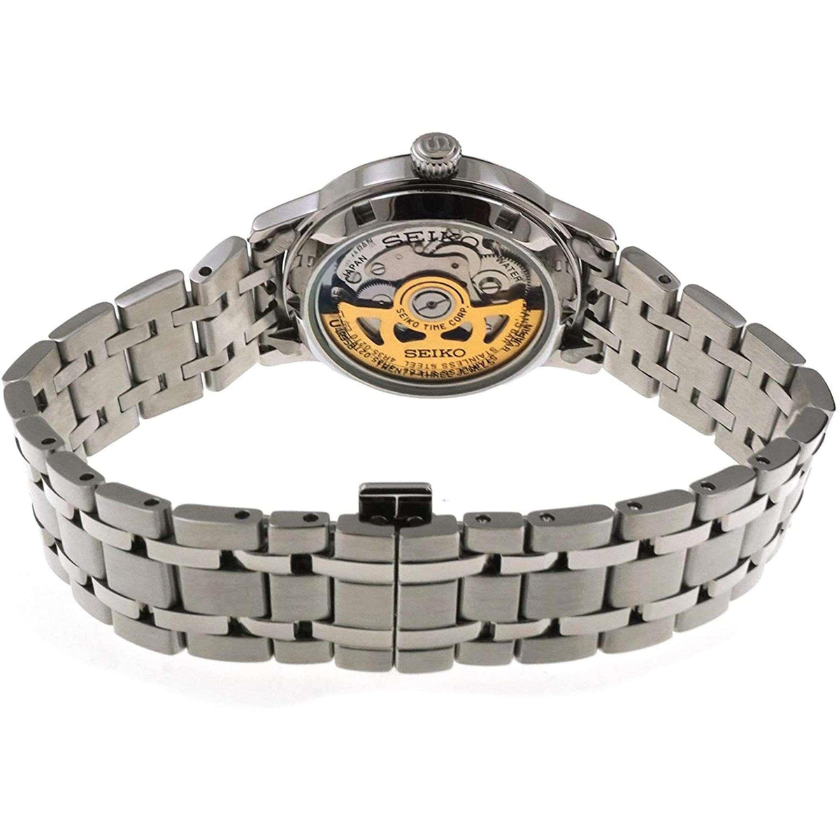 Stainless-steel watch case with open back showing gold and black movement