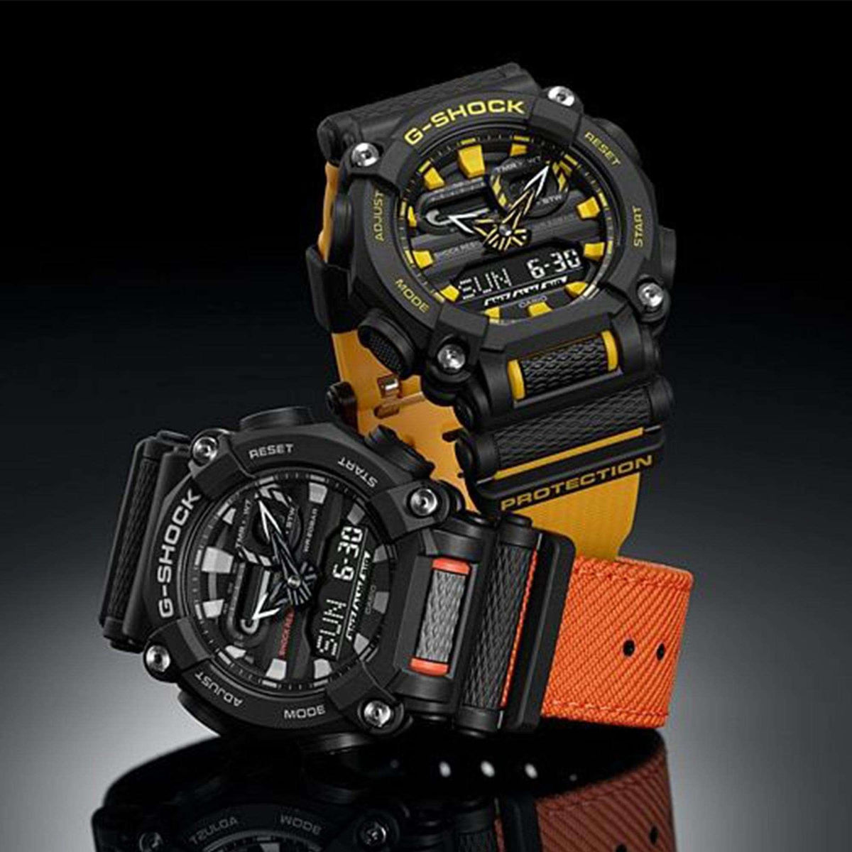Men's G-Shock quartz watch with black case, yellow and orange strap accents, angled dial view