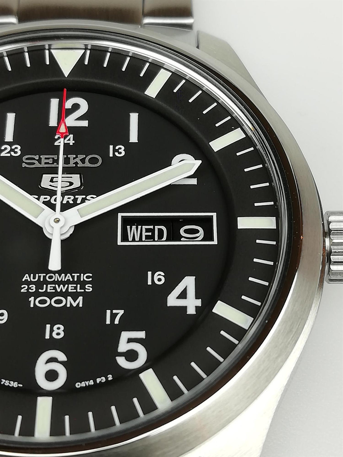 Seiko men’s black dial watch close-up with Seiko 5 Sports text and date window