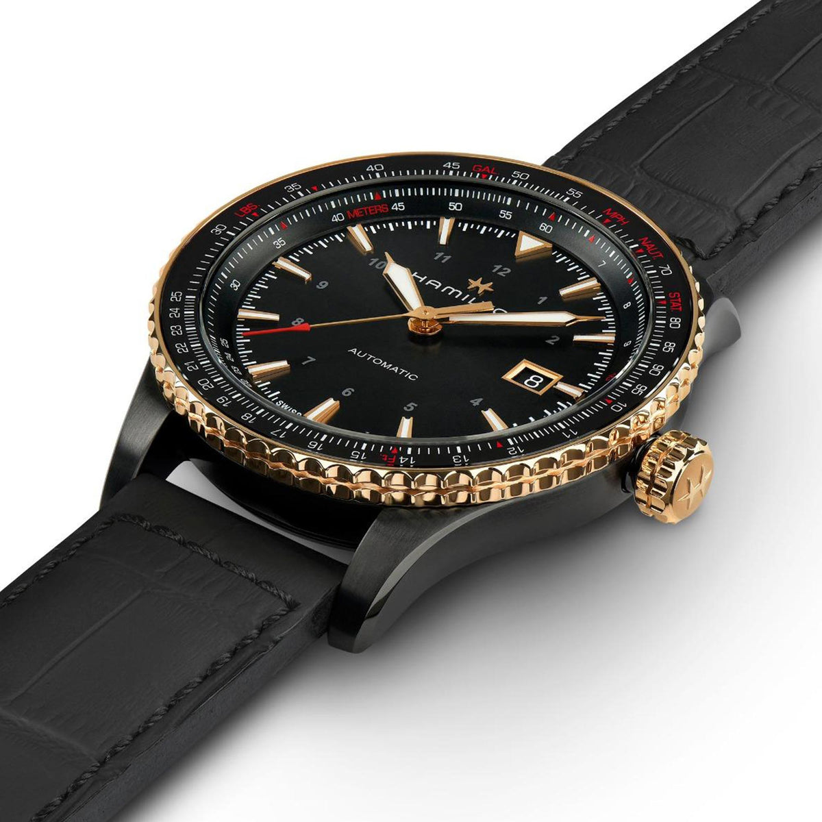 Men's automatic watch angled view, black dial with date window, black leather strap, gold bezel.