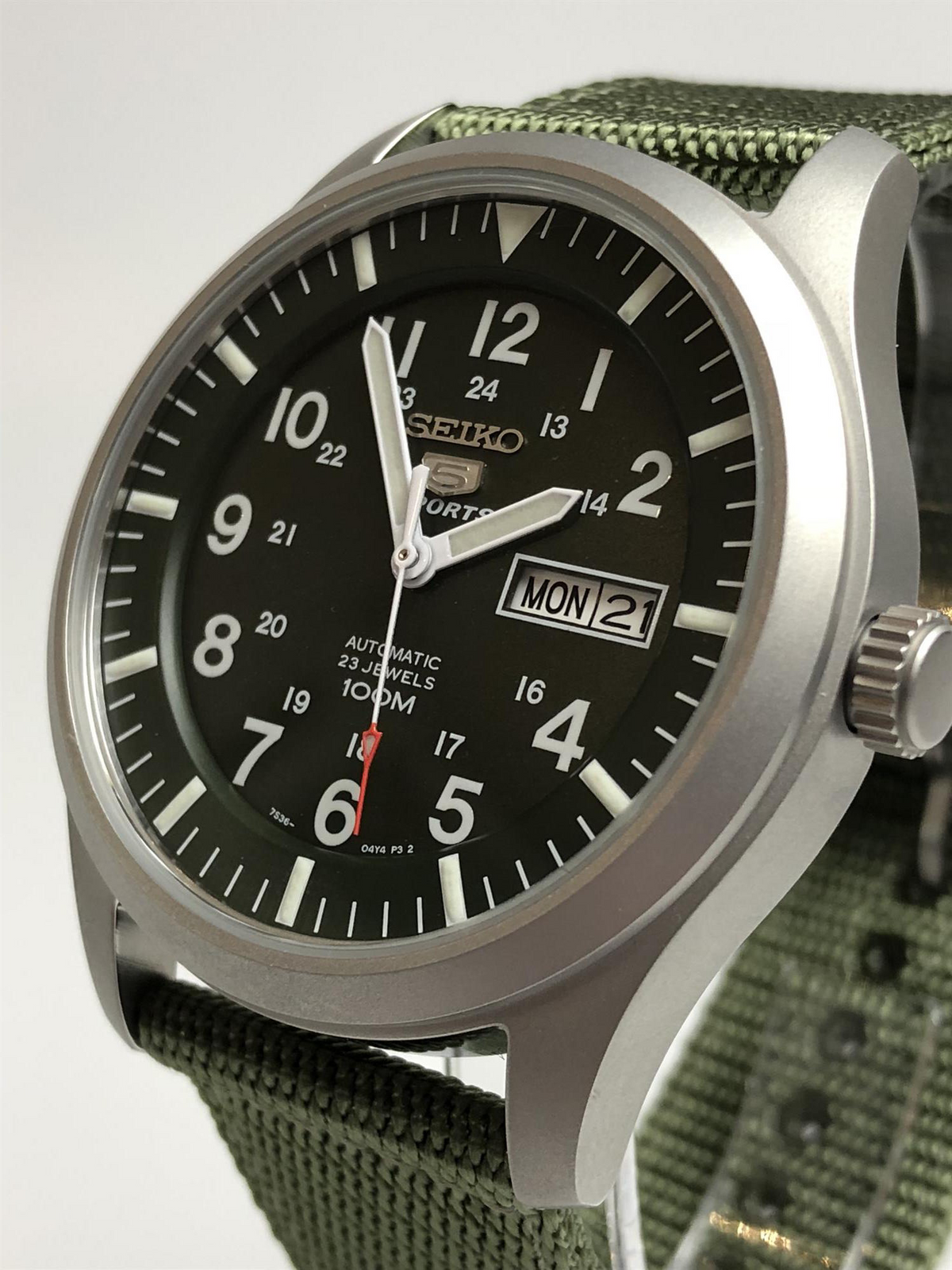 Men's automatic watch front quarter view with green dial and crown on right