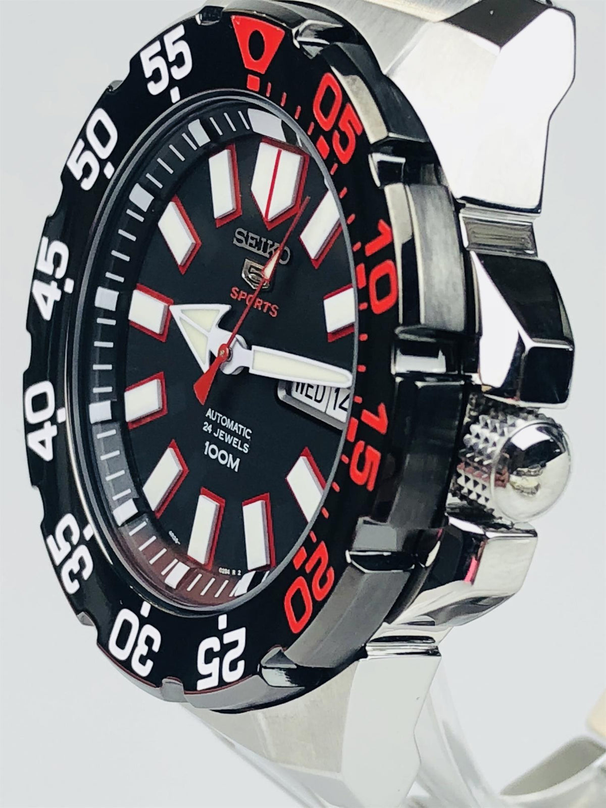 Seiko Sports men’s watch angled view, black dial with red bezel markers and steel case