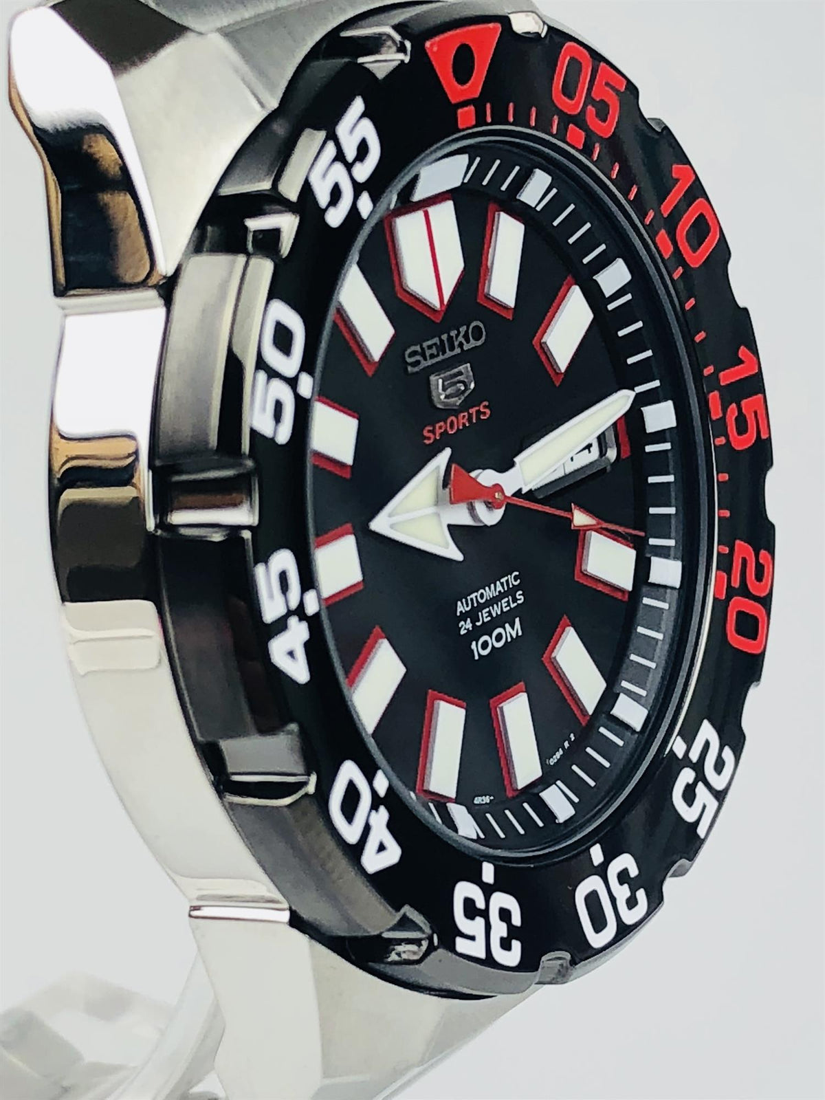 Seiko Sports men’s watch side view with black dial, red accents, and steel bracelet
