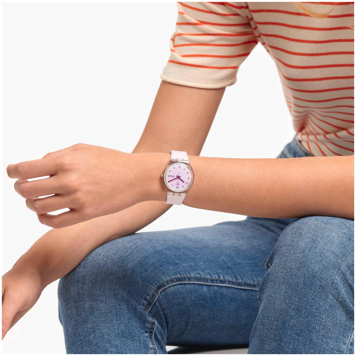 Wristwear view of pink silicone strap watch with purple dial and Fri 28 date