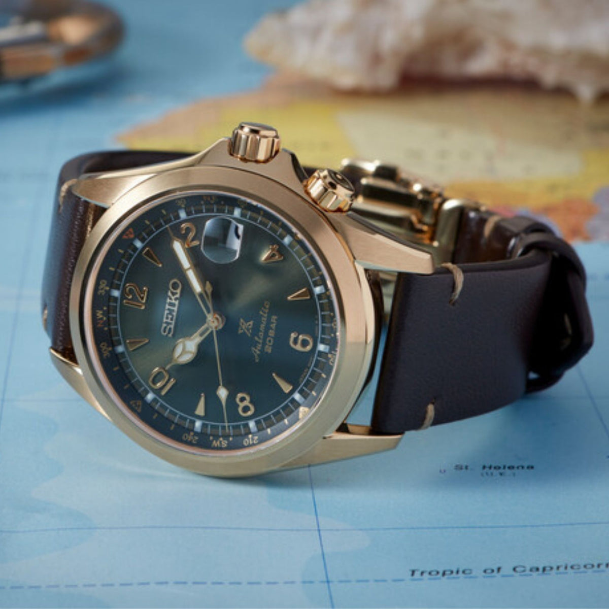 Men's wrist watch with green dial, gold-tone case, and brown leather strap