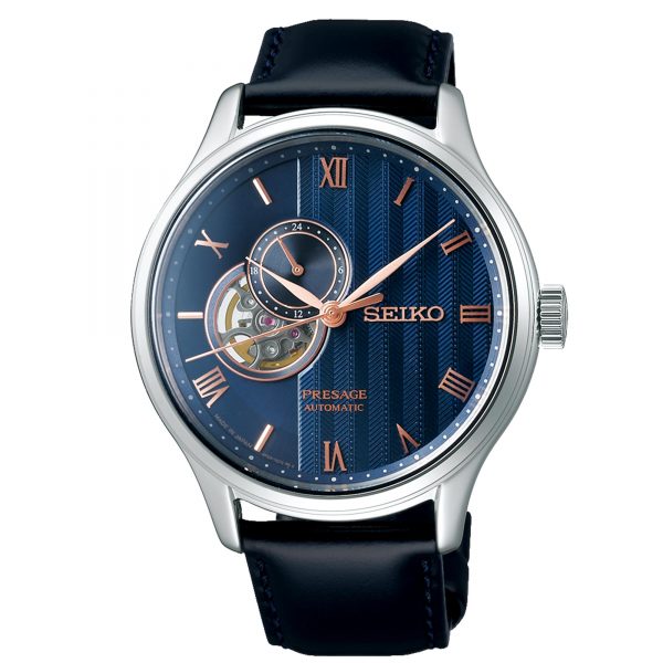 Seiko Presage watch front view with blue dial, Roman numerals, rose-gold hands, black strap