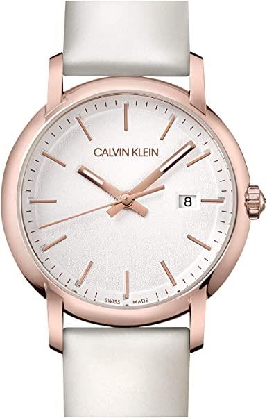 Ladies watch close-up: white leather strap, rose-gold case, silver dial with date 8