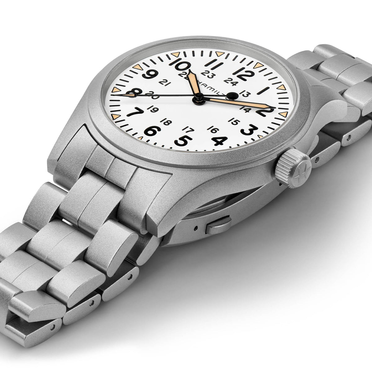 Steel bracelet mechanical watch with white dial and gold-tone accents, angled view