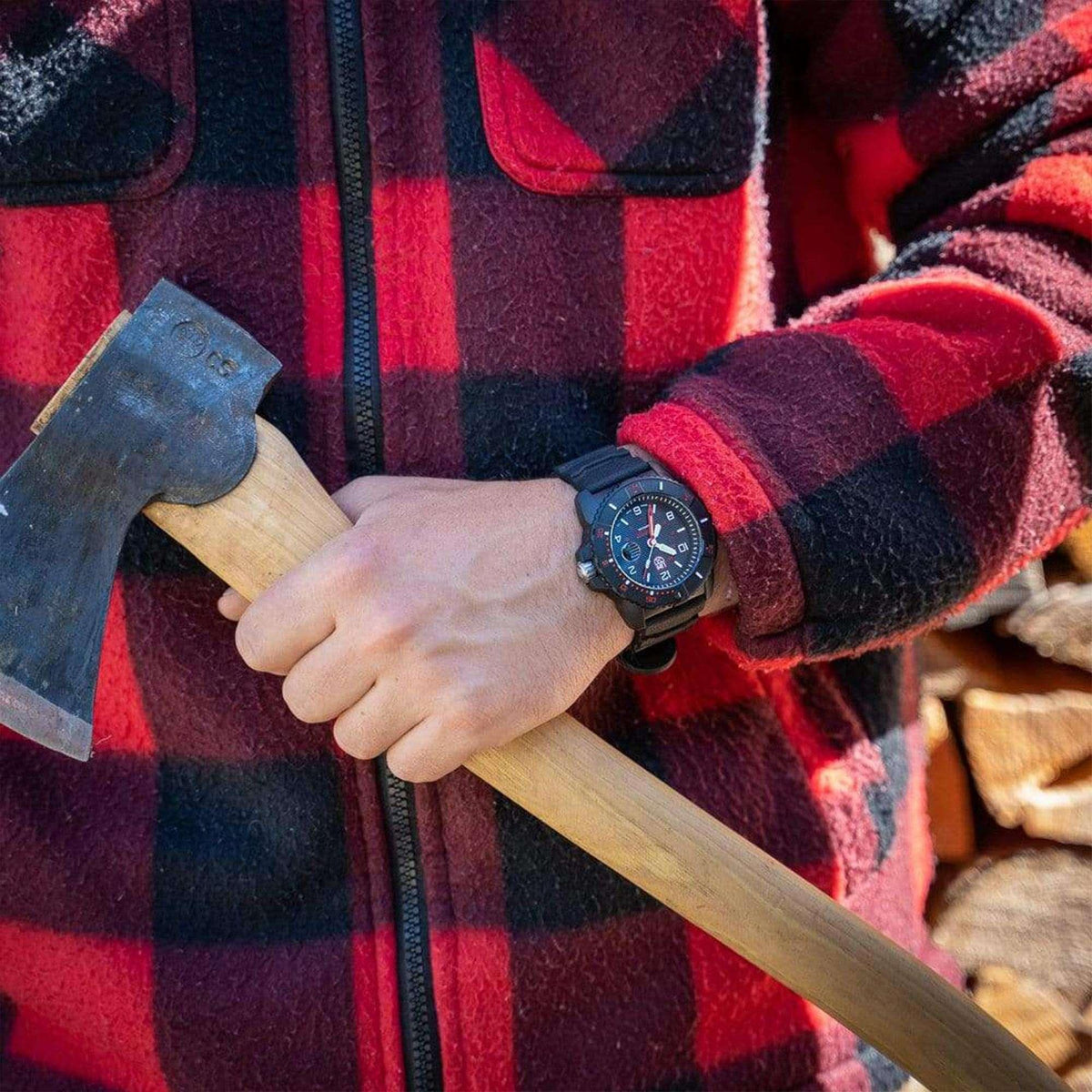 Men's wrist dive watch with black dial, red hands, and black rubber strap