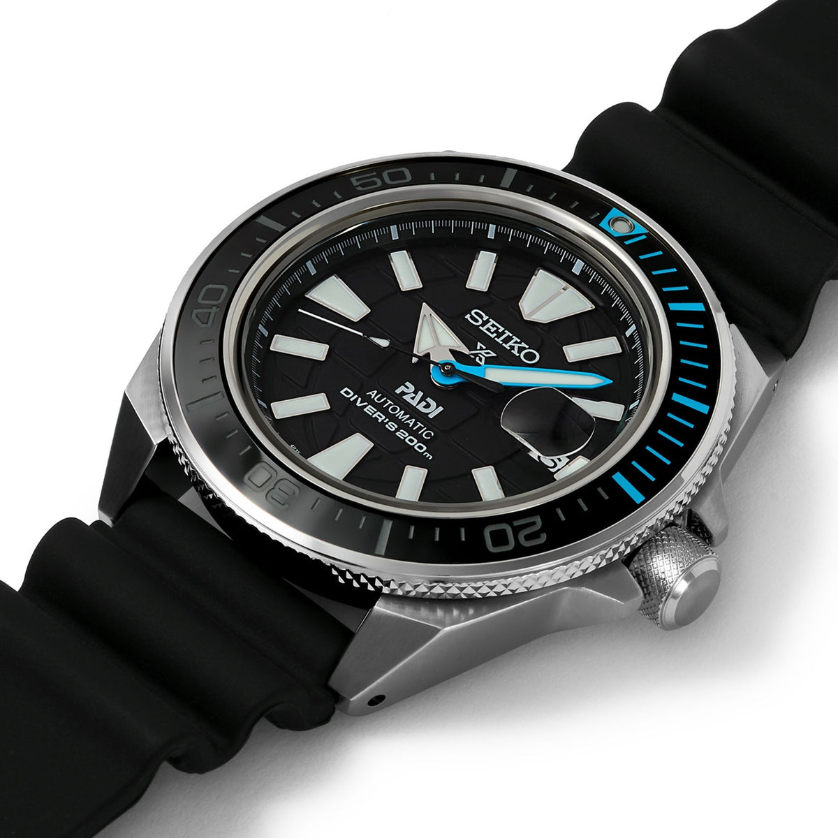 Seiko diver watch close-up: black bezel with blue markers and black silicone strap