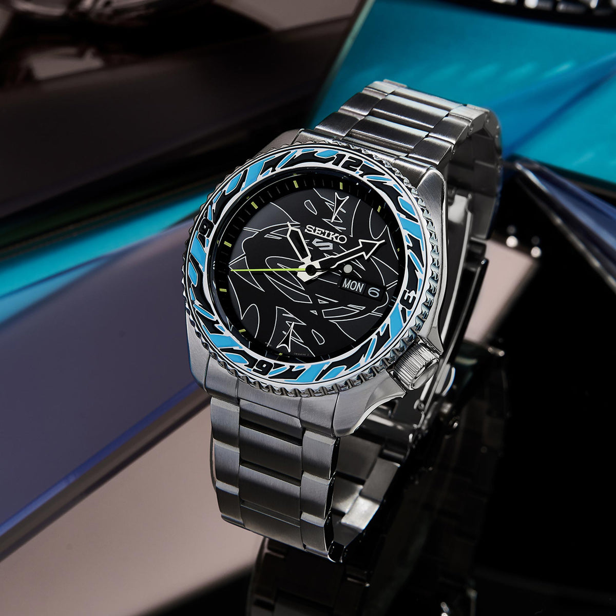 Seiko men's automatic wrist watch with black dial, blue bezel accents, stainless steel bracelet