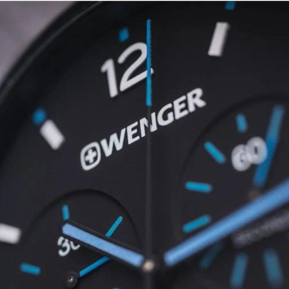 Men's chronograph watch dial close-up with Wenger branding and blue hour markers