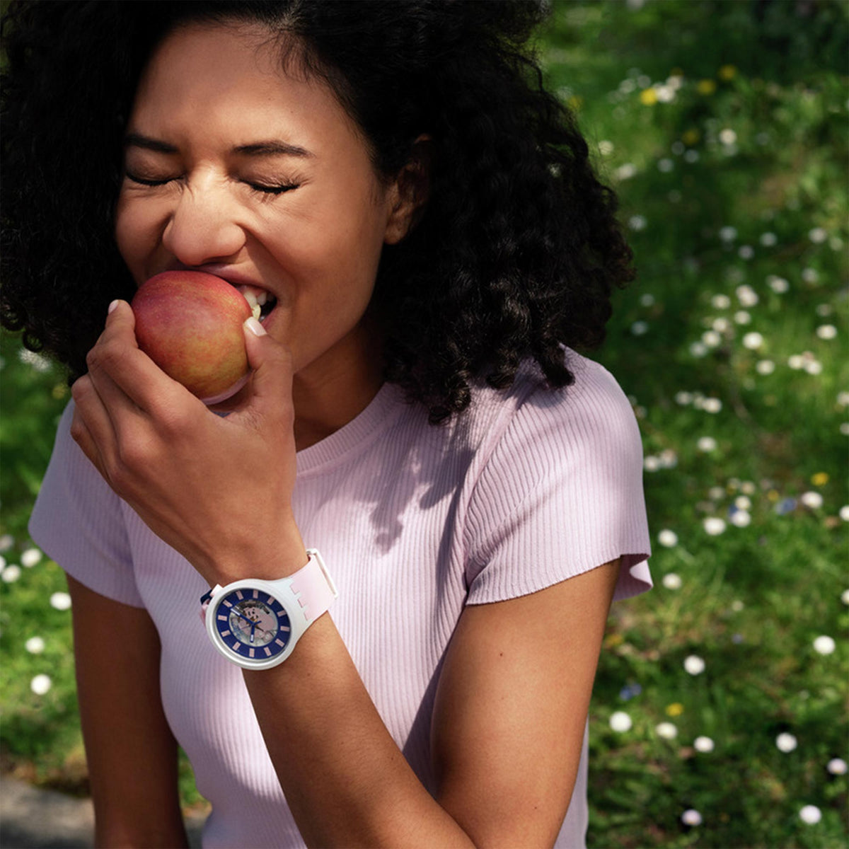 Quartz watch on wrist with blue dial and pink silicone strap