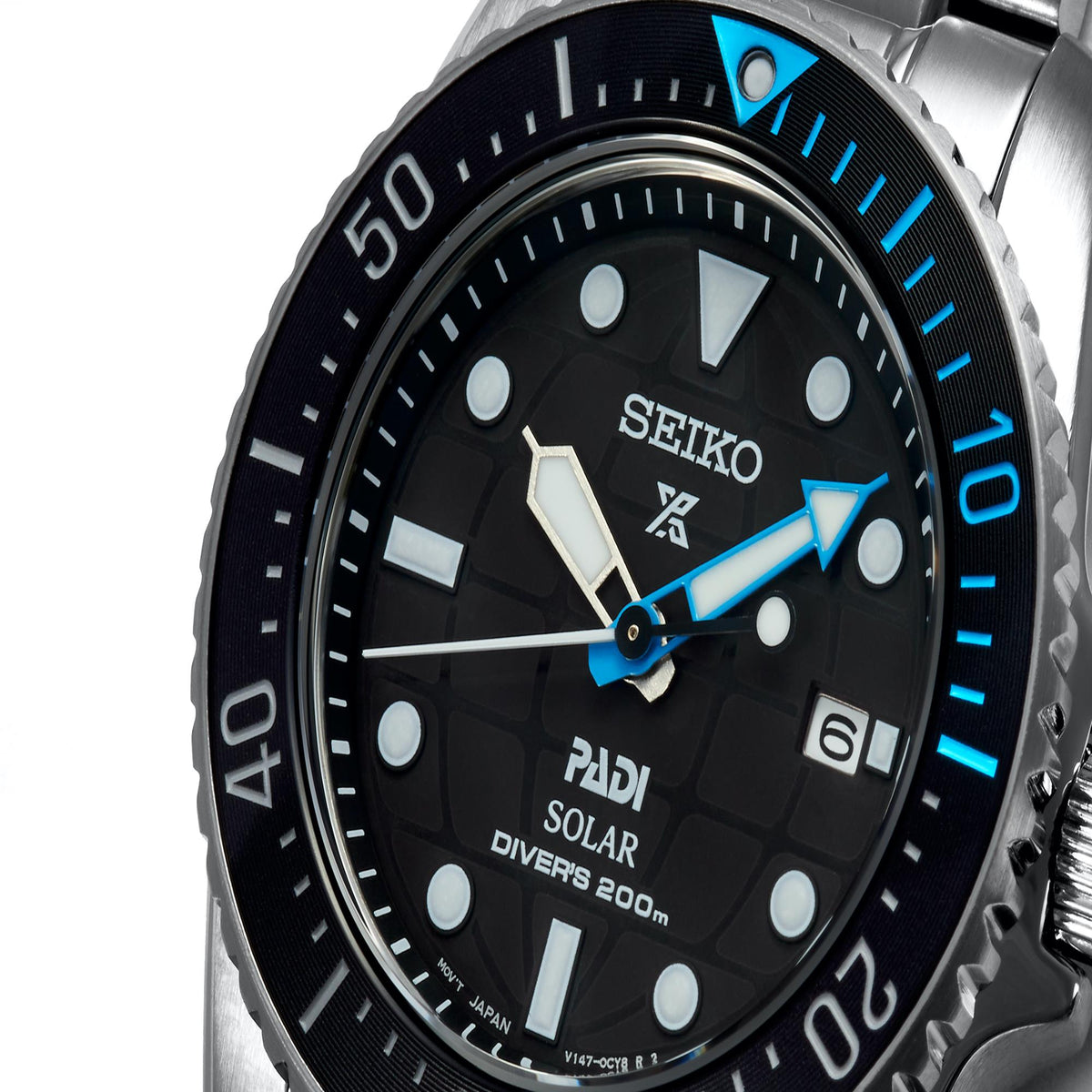 Close-up black dial solar dive watch with blue bezel marks and luminous markers
