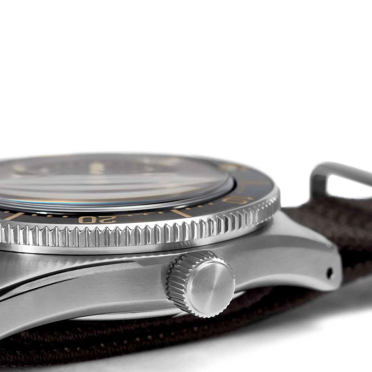 Close-up of a silver watch with a brown leather strap on a white background