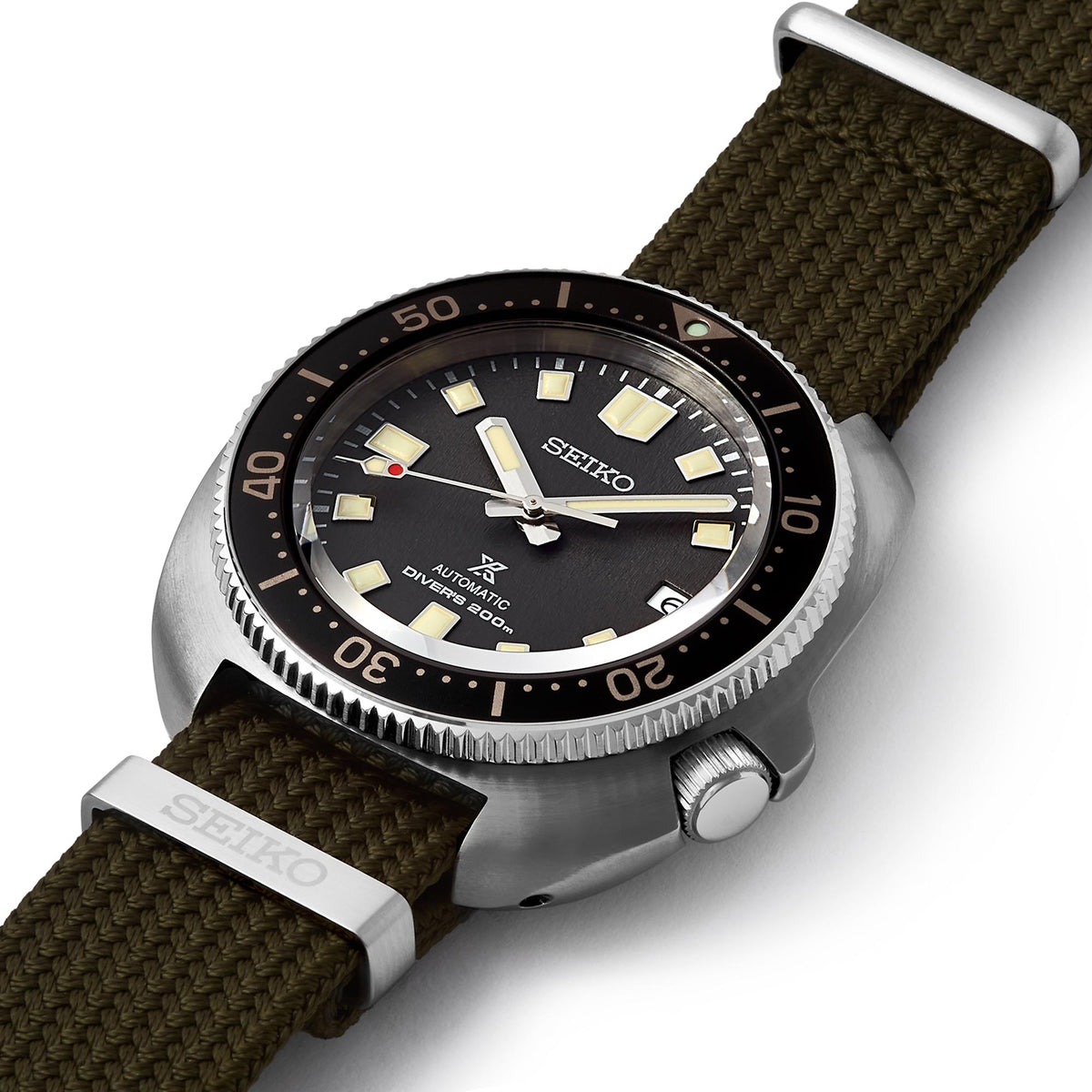 Seiko watch with brown strap and black dial on a white background