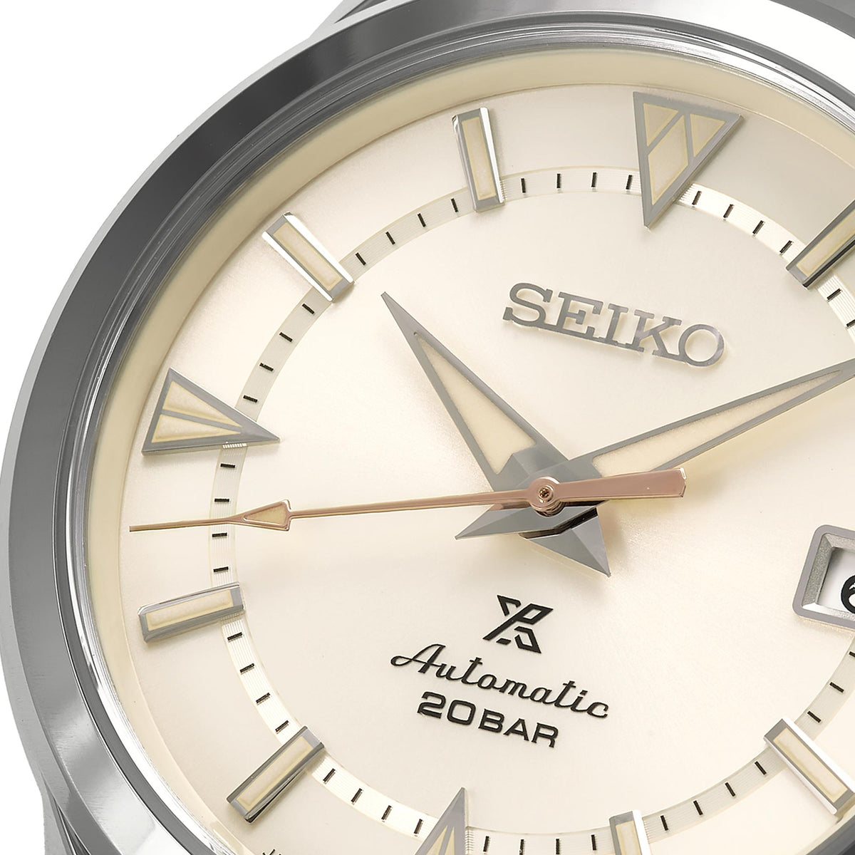 Close-up of cream Seiko dial with triangular hour markers and Automatic 20 BAR text